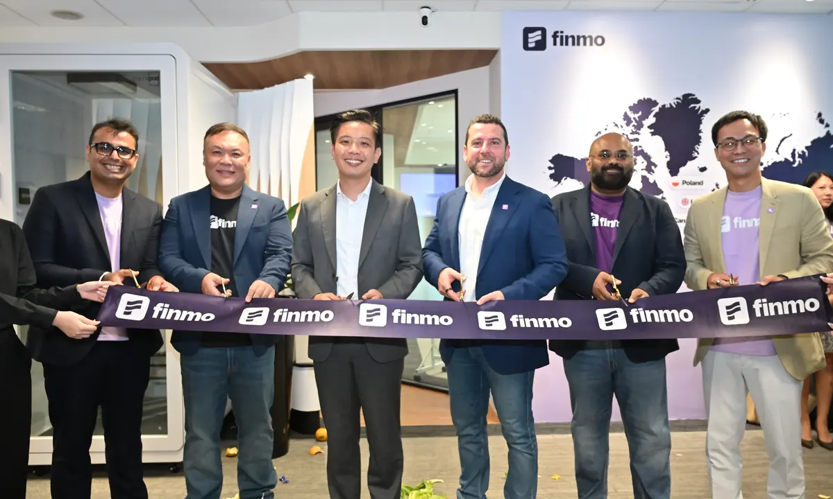 Finmo’s leadership and Alvin Tan hold a ribbon at the opening of Finmo’s Suntec City headquarters.